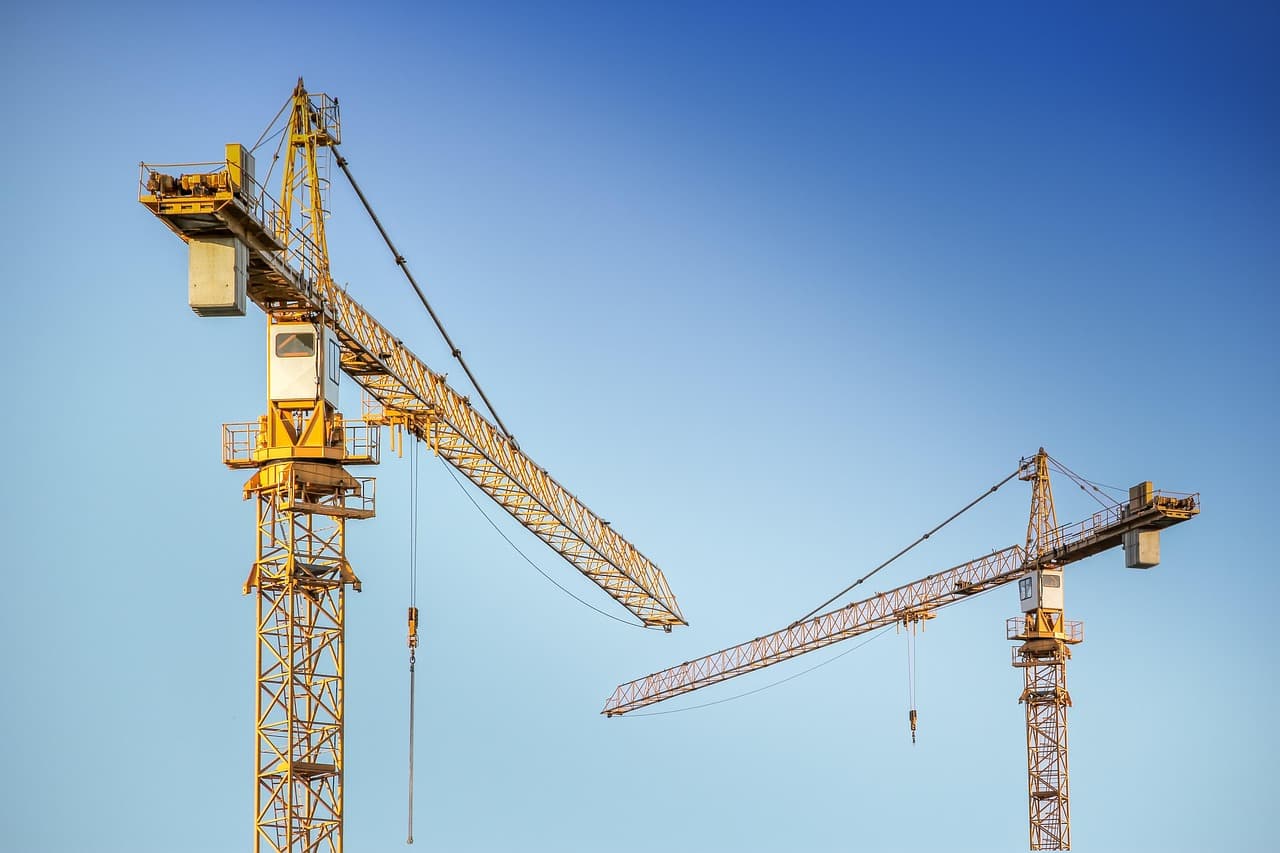Construction workers using digital tablets and BIM technology on a modern construction site